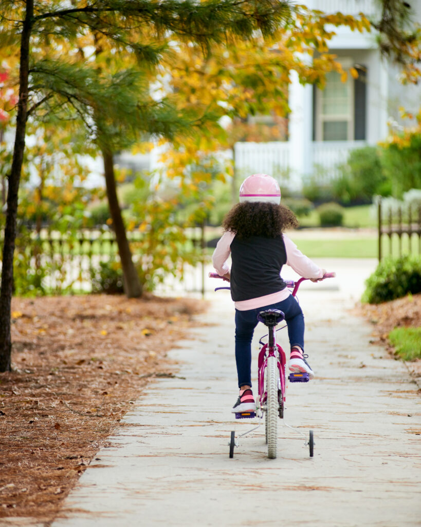 The Woodlands Girl Riding Bike on Pathway